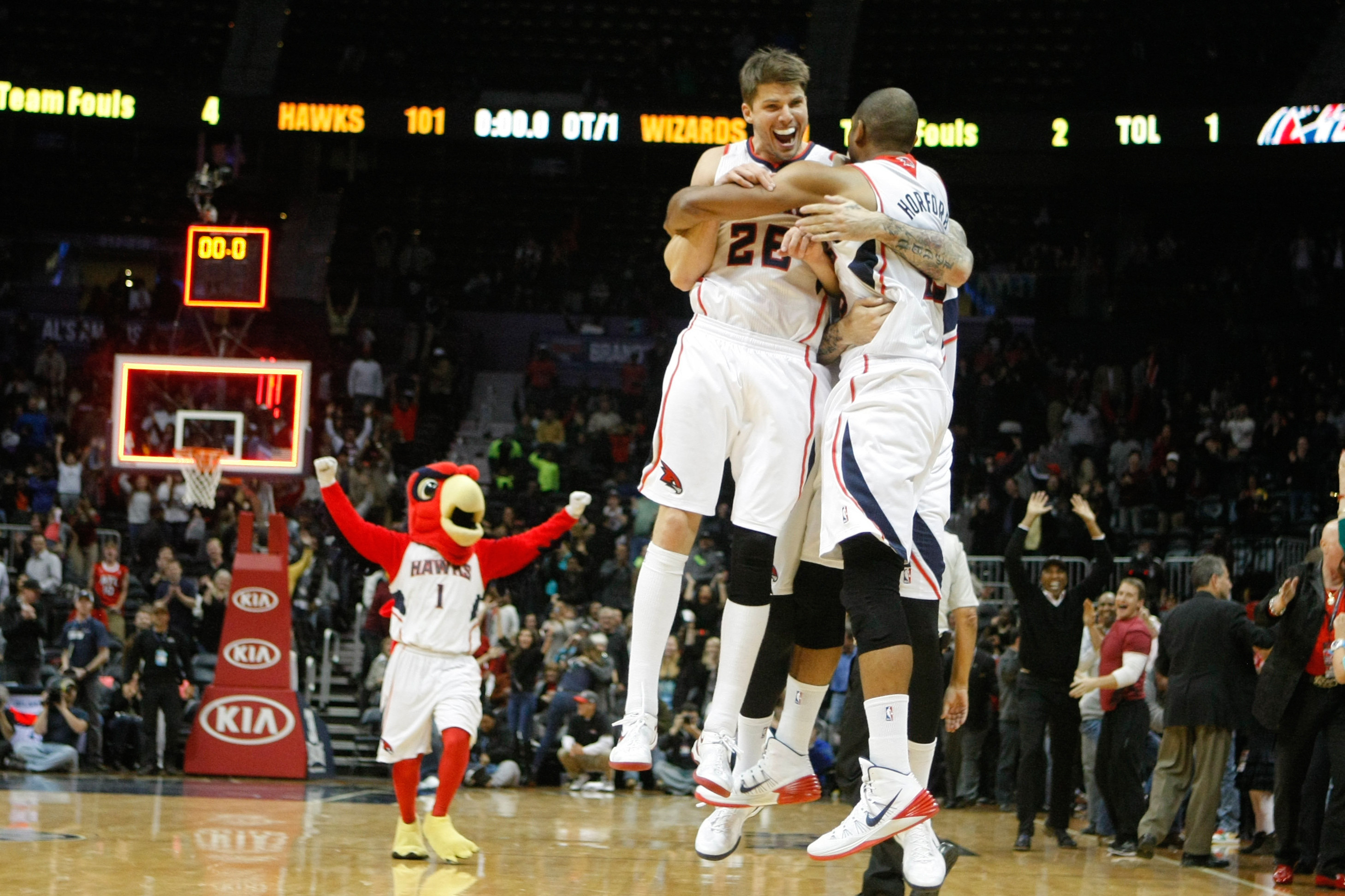 Dec 13, 2013; Atlanta, GA, USA; Atlanta Hawks shooting guard Kyle Korver (26) and center Al Horford (15) celebrate a victory against the Washington Wizards in overtime at Philips Arena. The Hawks defeated the Wizards 101-99. Mandatory Credit: Brett Davis-USA TODAY Sports